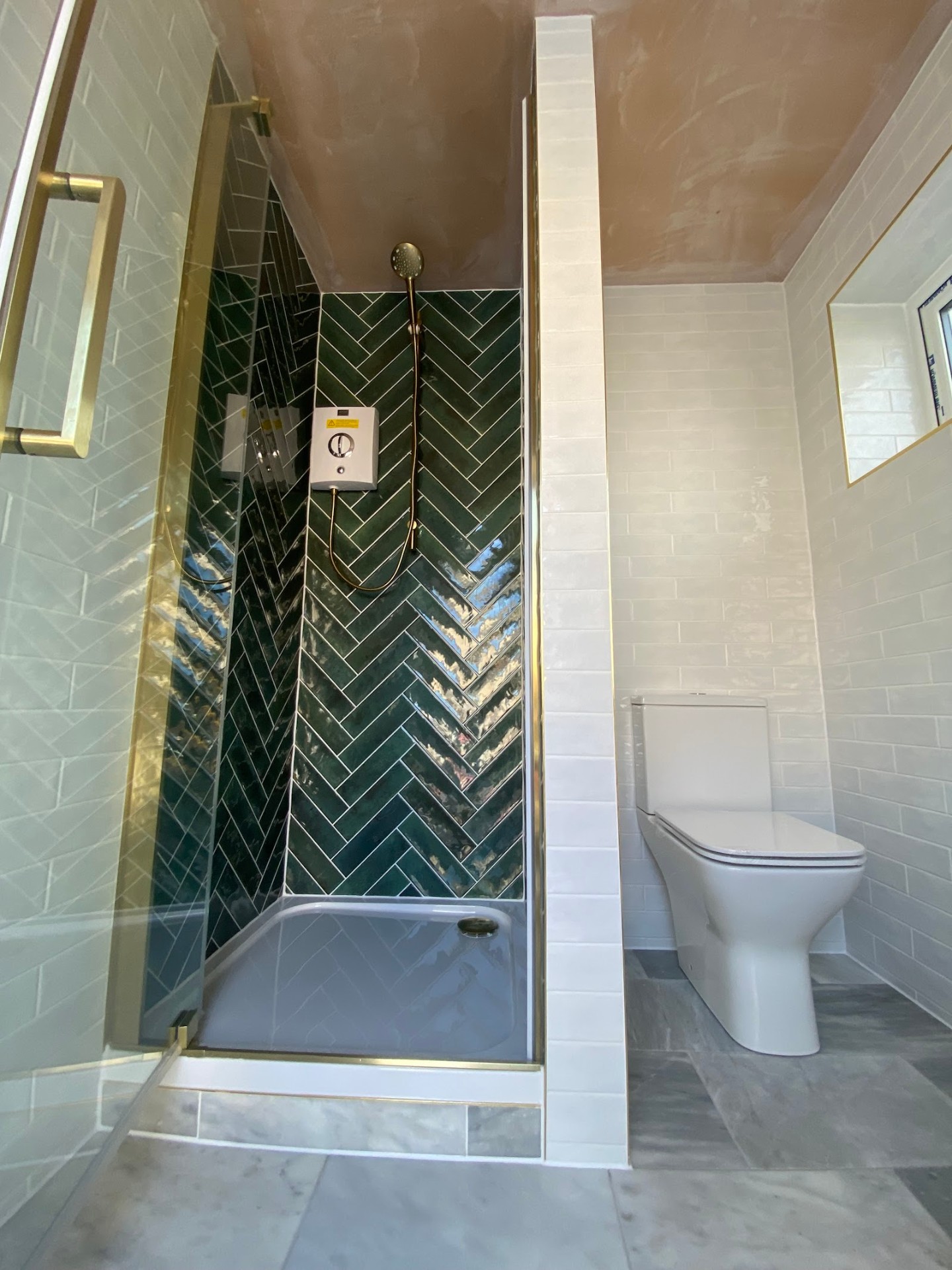 Green herringbone shower · brass
