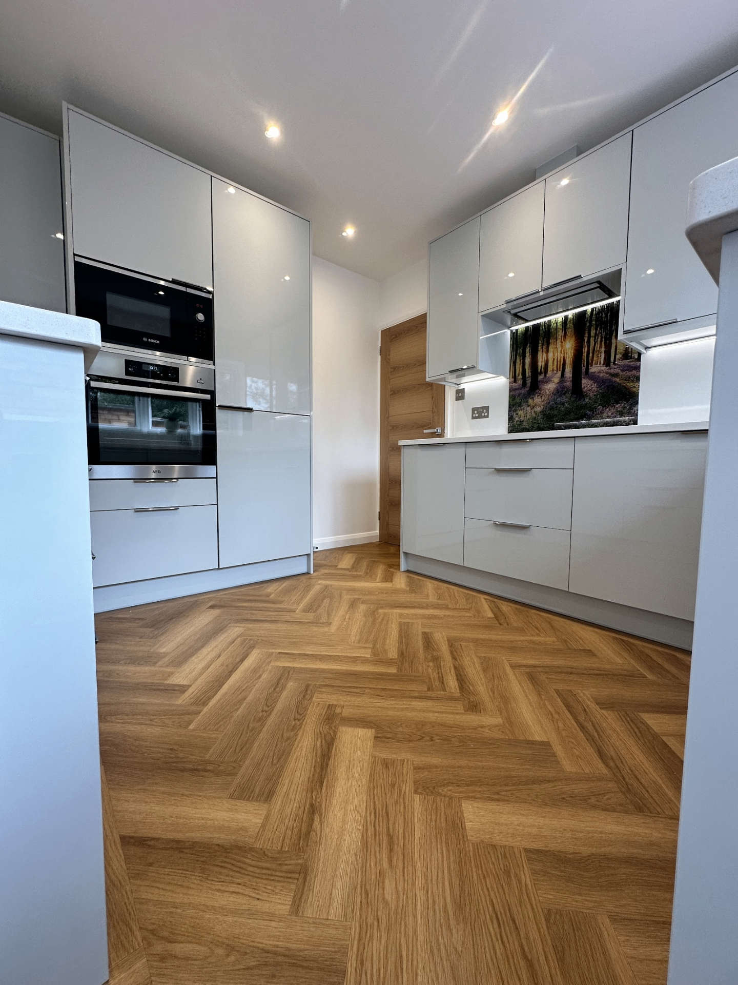 Herringbone LVT · gloss kitchen